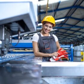 portrait-female-factory-worker-protective-uniform-hardhat-standing-by-industrial-machine-production-line_342744-225